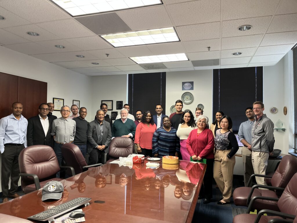 Group of people behind a large table in a conference room